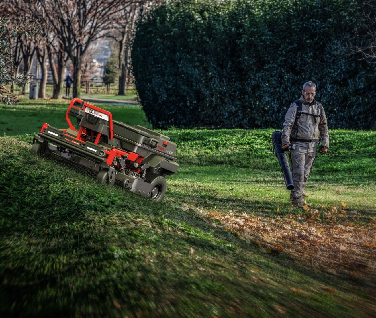 Commercial mower working beside a landscaped path